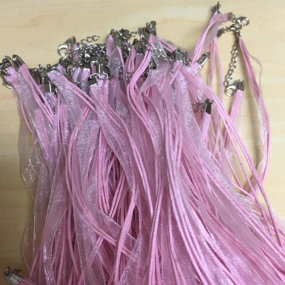 Set of 96 pink ribbon necklaces